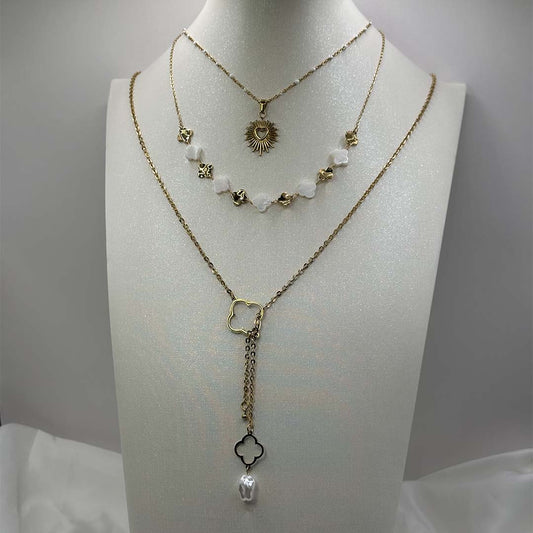 Trois jolis bijoux en acier inoxydable sont sur un buste pailleté blanc. C'est une composition des colliers "solia", "Inaya" et "trecia". Le tout est posé sur un tissu satiné blanc et sur un fond blanc.